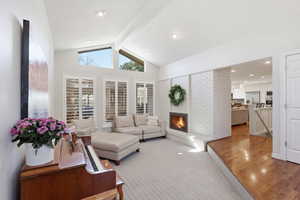 Living room featuring a brick fireplace, wood finished floors, and recessed lighting