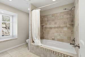 Full bath featuring tiled shower / bath combo, tile patterned floors, and recessed lighting