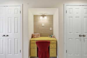 Home office featuring wood walls and baseboards