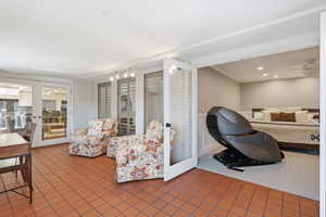Tiled living room featuring french doors, crown molding, and recessed lighting