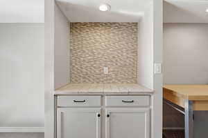 Detailed view of tasteful backsplash and baseboards