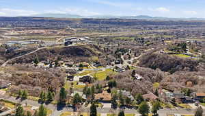 Aerial overview of property's location with nearby suburban area and a mountain backdrop