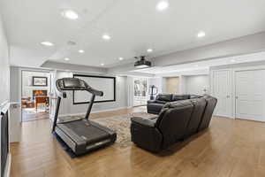 Workout area featuring light wood-type flooring and recessed lighting