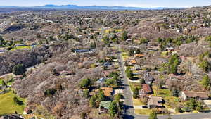 Aerial overview of property's location featuring mountains and nearby suburban area