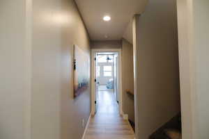 Hall with recessed lighting and light wood-style flooring