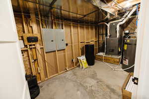 Utilities with electric panel, heating unit, and strapped water heater