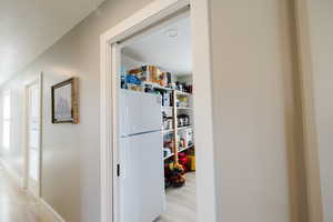 Corridor with light wood-type flooring