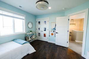 Bedroom featuring dark wood-style flooring and a closet