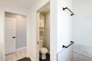 Bathroom featuring toilet and baseboards