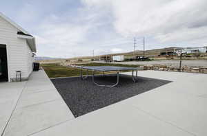 View of patio / terrace featuring a trampoline, a mountain view, and an outdoor structure