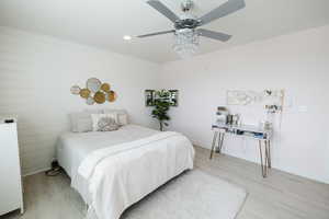 Bedroom with recessed lighting, light wood-type flooring, and a ceiling fan