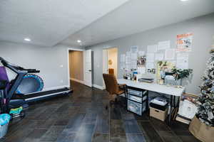 Office space featuring a textured ceiling and recessed lighting