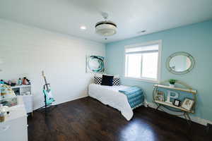 Bedroom with dark wood-type flooring