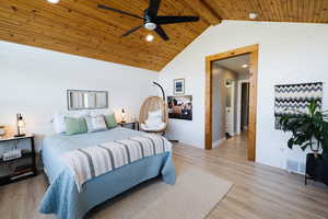Bedroom featuring wooden walls, light wood-type flooring, wooden ceiling, a ceiling fan, and recessed lighting