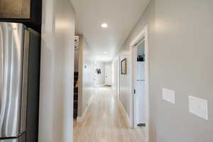 Corridor with recessed lighting and light wood-style floors