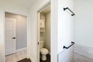 Bathroom with toilet and baseboards