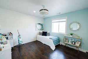 Bedroom with dark wood-style flooring