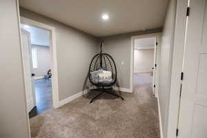 Corridor with carpet and recessed lighting