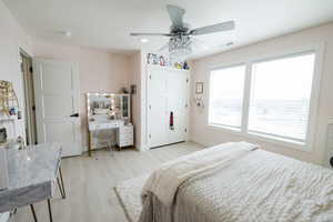 Bedroom featuring ceiling fan, light wood-type flooring, a closet, recessed lighting, and a desk