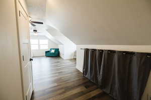 Hallway with dark wood finished floors and baseboards