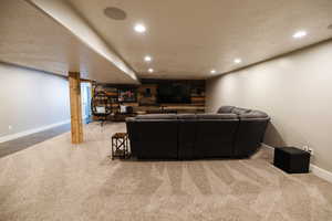 Living room featuring recessed lighting, a textured ceiling, and light colored carpet
