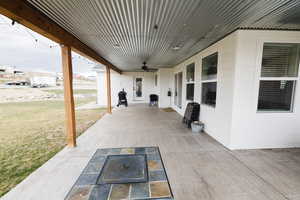 View of patio featuring ceiling fan and area for grilling