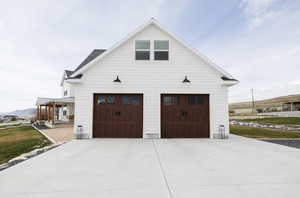Garage featuring driveway and a mountain view