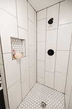 Full bath featuring tiled shower