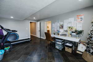 Home office featuring a textured ceiling and recessed lighting