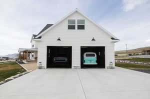 Garage with concrete driveway and a mountain view