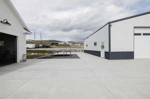 View of patio featuring a mountain view, an outbuilding, and a detached garage