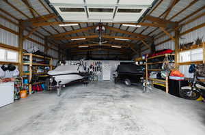 Garage featuring white refrigerator and a garage door opener