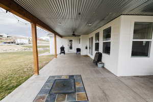 View of patio featuring ceiling fan and a grill