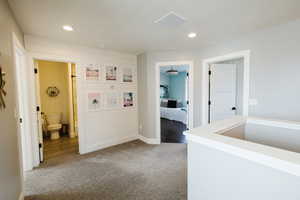 Hallway with carpet flooring and recessed lighting