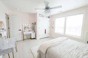 Bedroom with ceiling fan, light wood finished floors, a closet, and recessed lighting