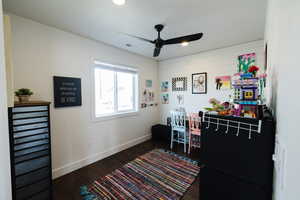 Office area featuring dark wood-type flooring, a ceiling fan, and recessed lighting