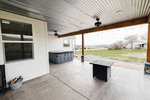 View of patio / terrace featuring ceiling fan and a hot tub
