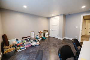 Home office featuring dark wood-type flooring, recessed lighting, and a textured ceiling