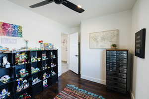 Bedroom featuring dark wood-style floors and a ceiling fan