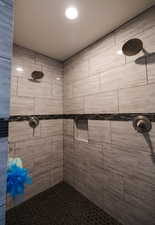 Full bath featuring a tile shower