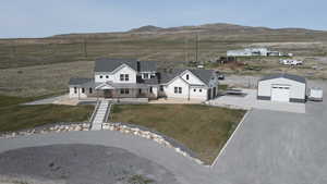 Aerial view of property and surrounding area with a mountain backdrop