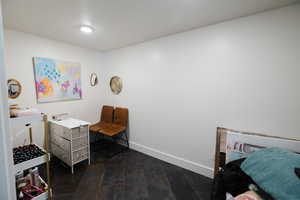 Bedroom featuring dark wood-type flooring and a textured ceiling