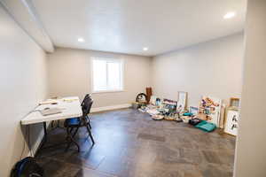 Recreation room with a desk, recessed lighting, and a textured ceiling