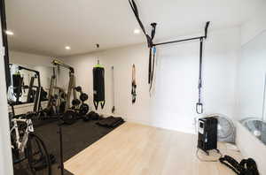 Workout room featuring recessed lighting and light wood-style flooring