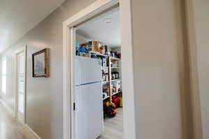 Hallway with light wood-style flooring