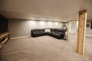 Living room featuring light carpet, a textured ceiling, and recessed lighting