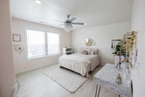 Bedroom with recessed lighting, a ceiling fan, wood finished floors, and wooden walls