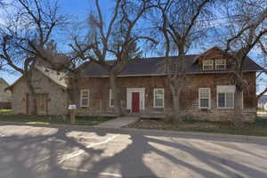 View of front of house with roof with shingles
