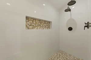 Full bathroom featuring a tile shower