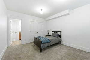 Bedroom featuring light colored carpet and a closet